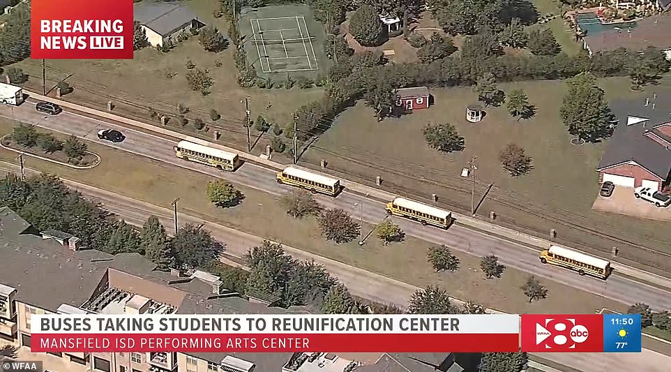 A convoy of school buses transported students to a family reunification center nearby