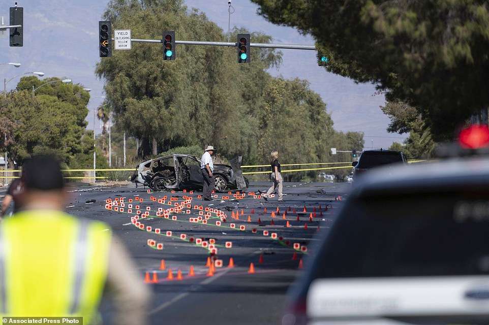 Las Vegas Metro Police investigators work at the scene of Tuesday's fatal crash