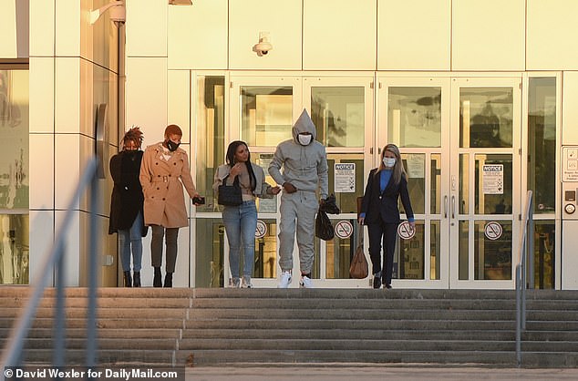 The rapper is seen on Friday evening leaving federal court in Central Islip, on Long Island in New York. He was freed on a $500,000 bond. He was holding hands with his girlfriend, and his sister Divinity Maxwell walked beside her, in a brown trench coat