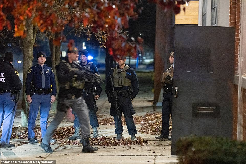 Police including State Troopers and US Marshalls from the Fugitive Task Force search a building of interest in the manhunt